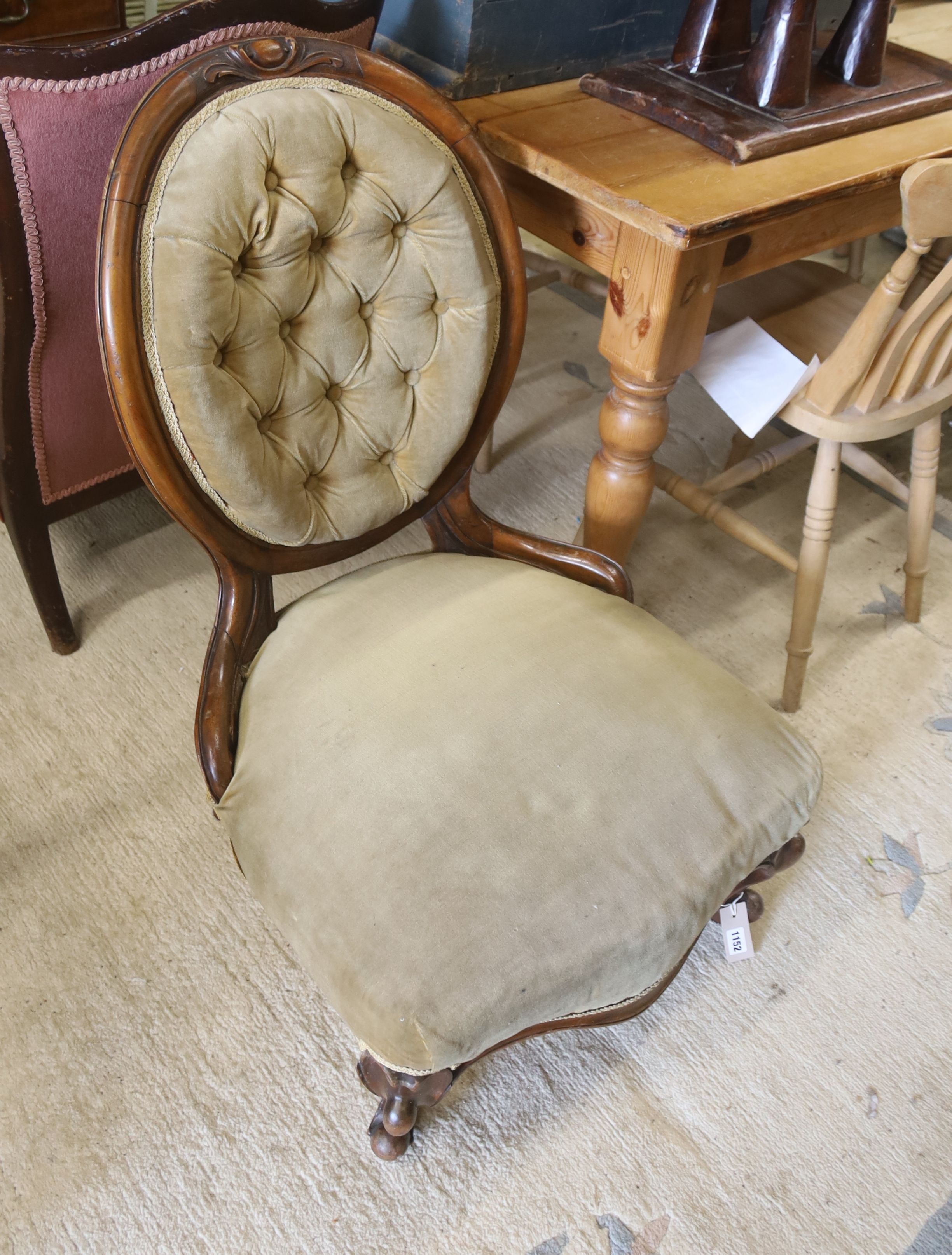 A Victorian walnut spoonback nursing chair